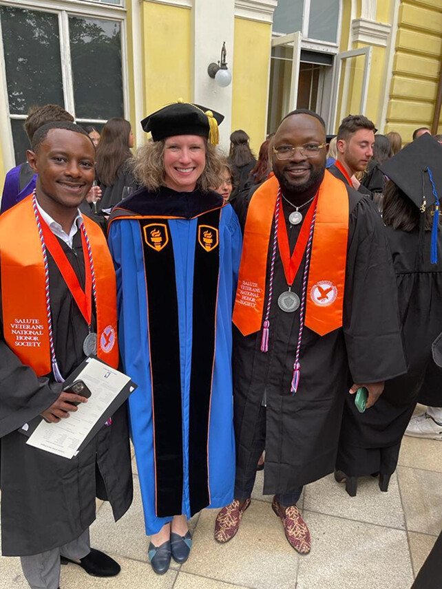 NYS University graduates with a faculty member